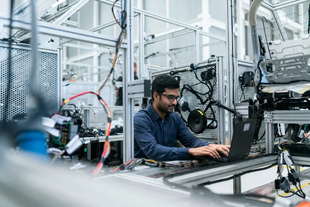 Bangladeshi network engineer working on technical equipment